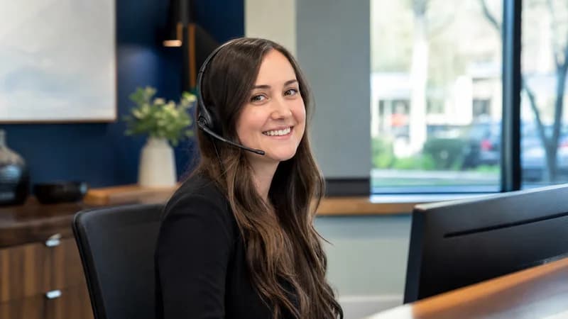 Receptionist wearing a headset at Hausman-Kunkel Insurance